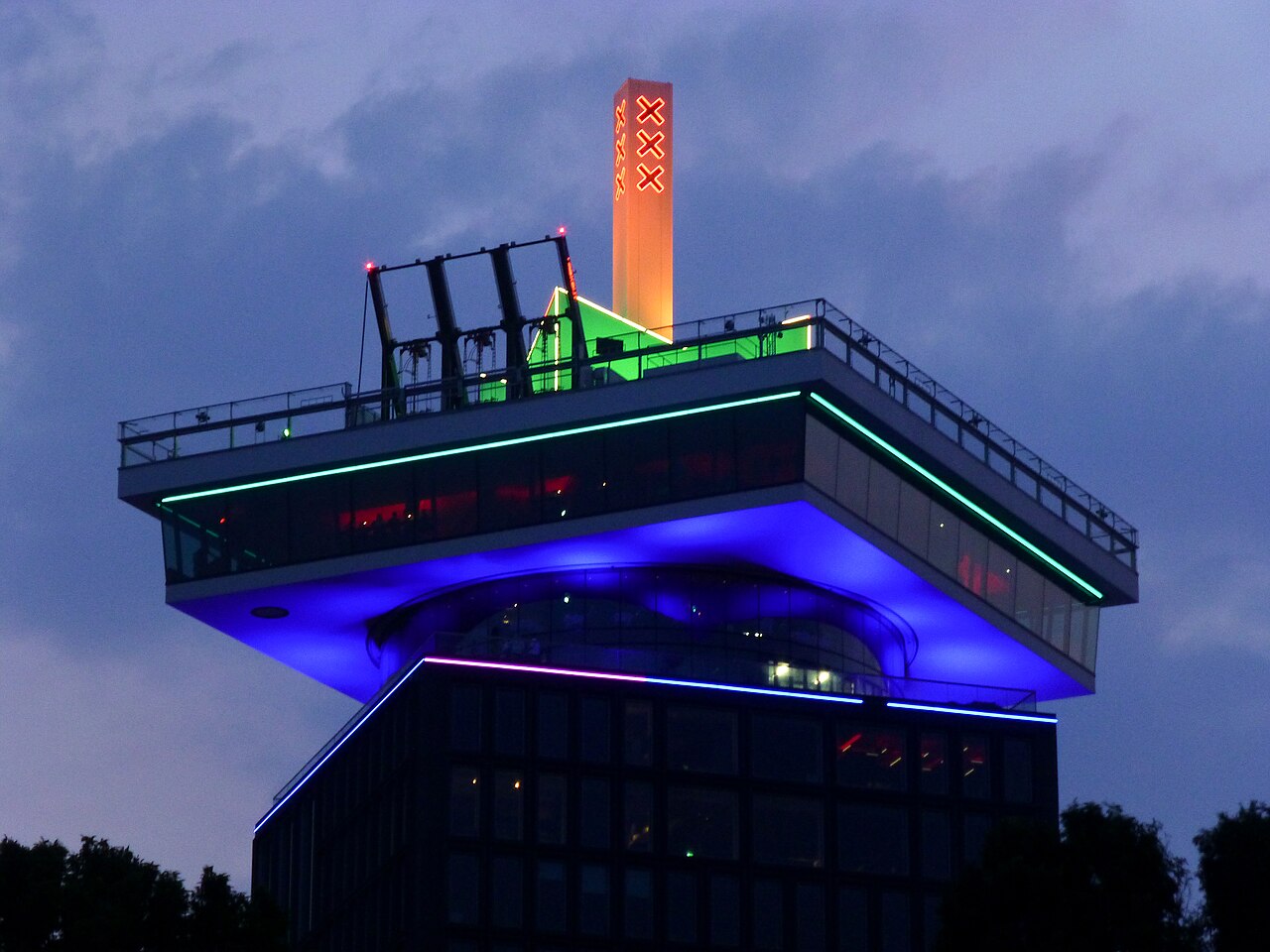 The A'DAM Tower lit up at dusk, above the Shelter club