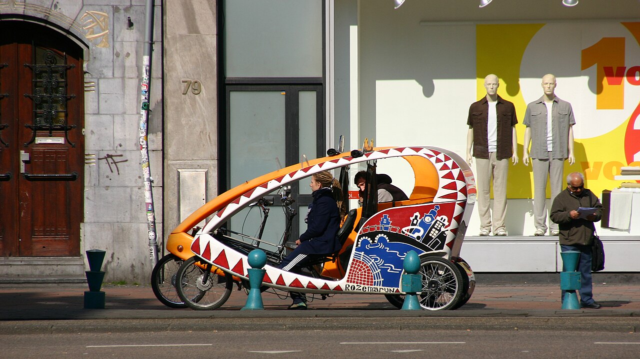 Decorated bike taxi parked on the Damrak