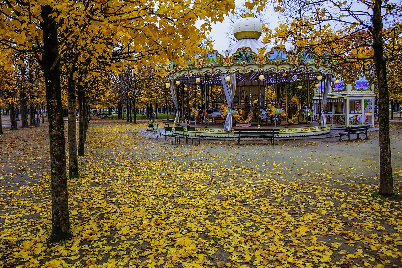A path in the Tuileries garden covered with fallen leaves in November