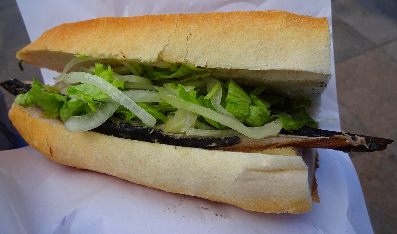 Sandwich balık ekmek au poisson grillé, salade et oignon, près du pont de Galata