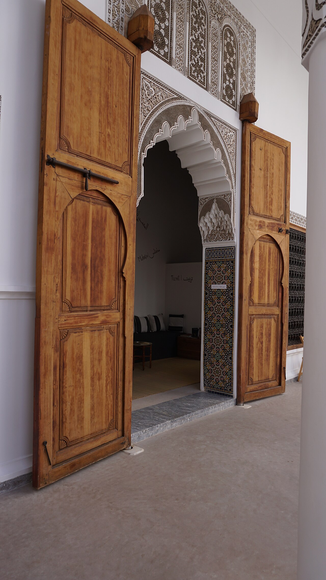 Carved doorway opening onto an exhibition room at Dar Bellarj
