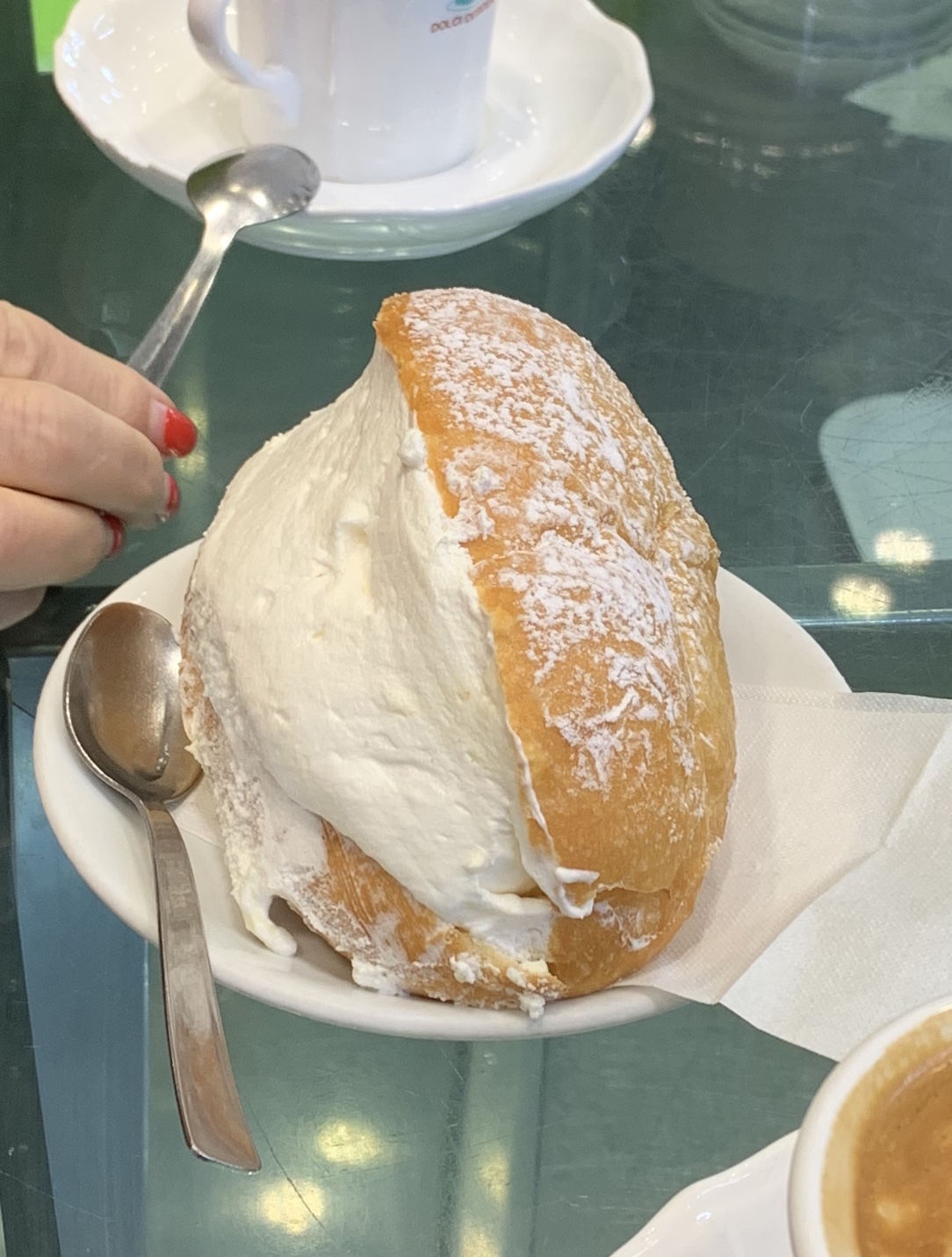 Maritozzo fourré de crème fouettée, servi avec un café