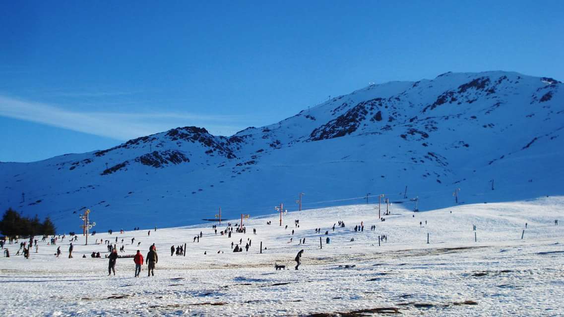 The snowy slopes of Oukaimeden under a blue Atlas sky