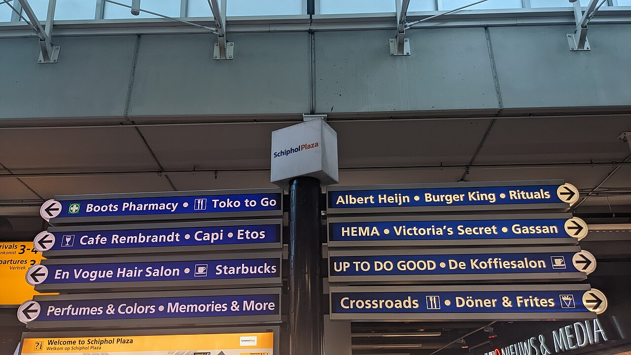 Signs pointing to the shops of Schiphol Plaza at the airport