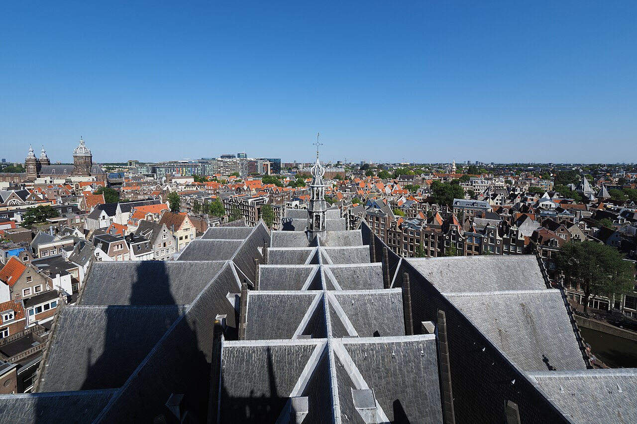 De daken van de Oude Kerk en het centrum van Amsterdam gezien vanaf de toren