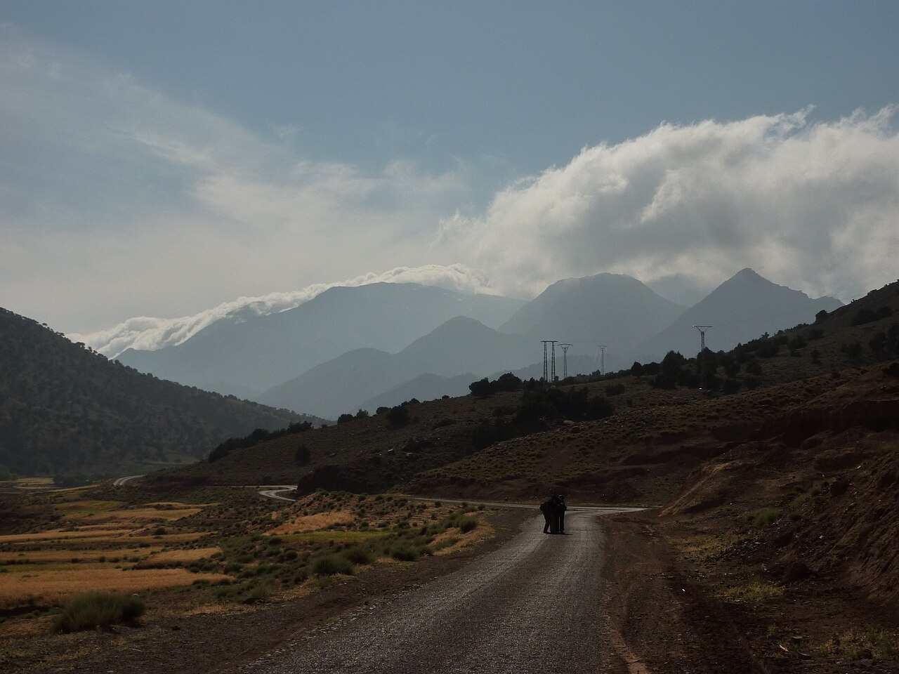 Narrow road leaving Telouet, in front of the High Atlas peaks