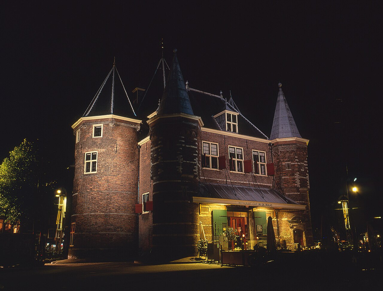 The Waag lit up at night on the Nieuwmarkt